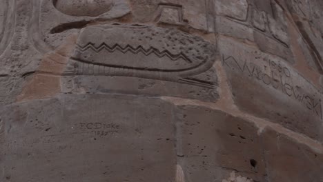 close up of ancient egyptian temple column inscription on it from past travelers