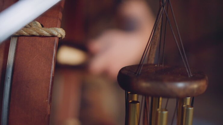 Musician plays shamanic drum and wind chimes at concert