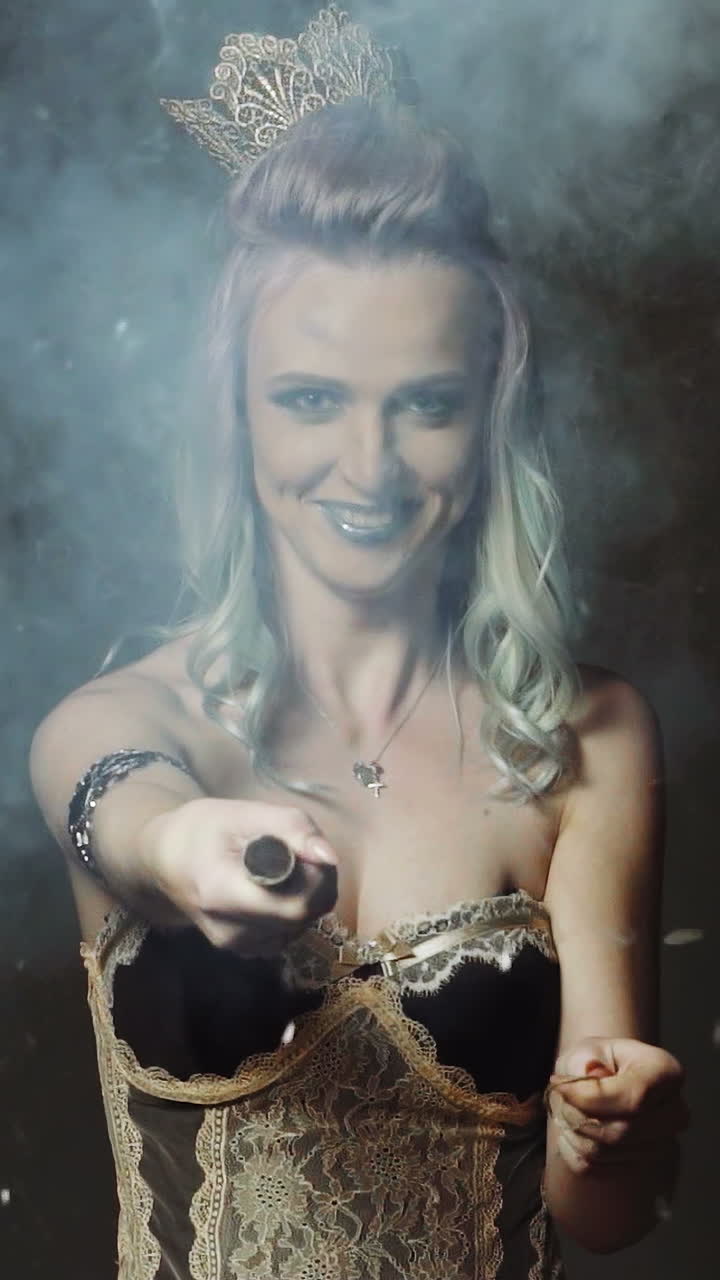 Woman blowing up flapper. Close up of young girl blows up flapper with excited face expressio