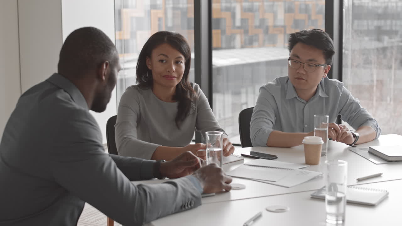 Three Diverse Colleagues Brainstorming in Office