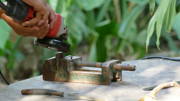 Worker grinding metal construction