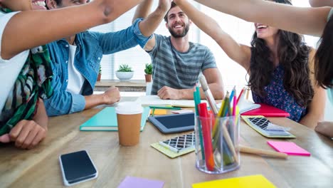 Video-of-creative-diverse-male-and-female-colleagues-high-fiving-in-modern-office