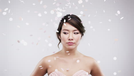 woman in a light pink dress with confetti