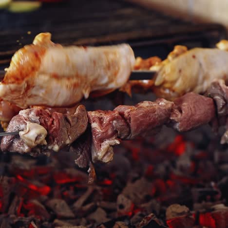 meat cooking on charcoal. delicious barbeque on metal skewers. process of frying juicy meat. close-up.