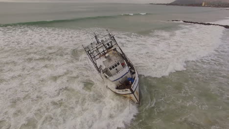 aerial shot over a shipwrecked fishing boat near ventura california 2