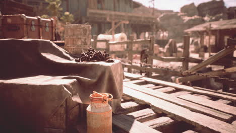 rustic wooden dock with a milk jug and old barrels at a mining town