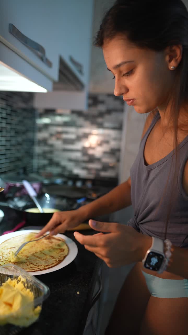 Woman Cooking Pancakes in Kitchen