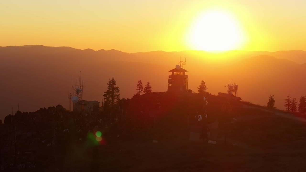 Fire lookout tower during Californian sunset, warm serene atmosphere