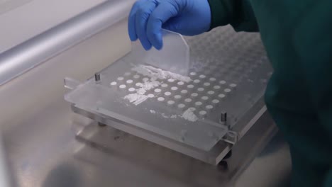 scientist making pills with formula and molds