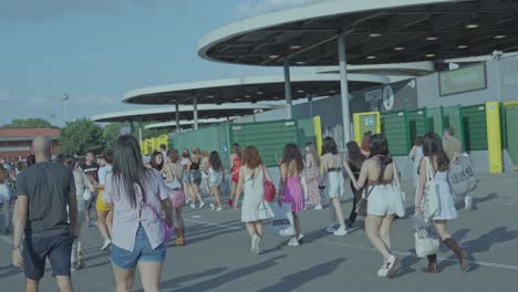 large crowd arriving at an outdoor festival entrance