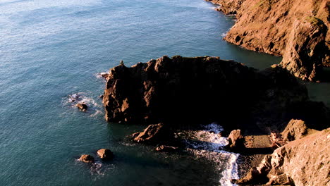 Aerial-Angled-view-of-vivid-Oregon-Coast-turquoise-water-and-Sea-Stacks-at-Sunrise