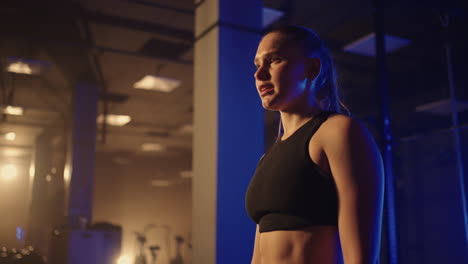 motivated sporty woman in gym young athlete is resting after exercise for keeping fit