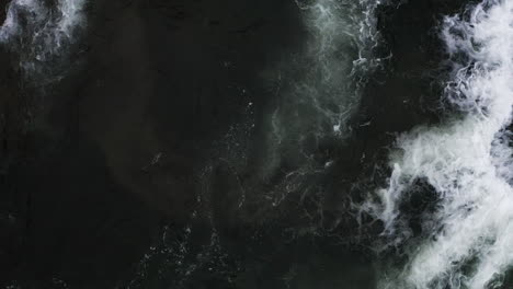 overhead view of the plunge pool at the bottom of a forest watefall