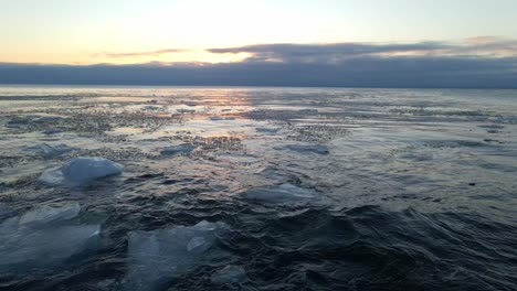 waves crashing on the shores of lake superior icebergs formations floting on the water