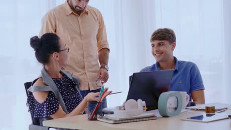 Group-meeting-of-creative-business-people,-designer-and-artist-at-office-desk.