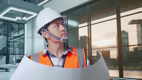 architect reviewing blueprints in a modern office