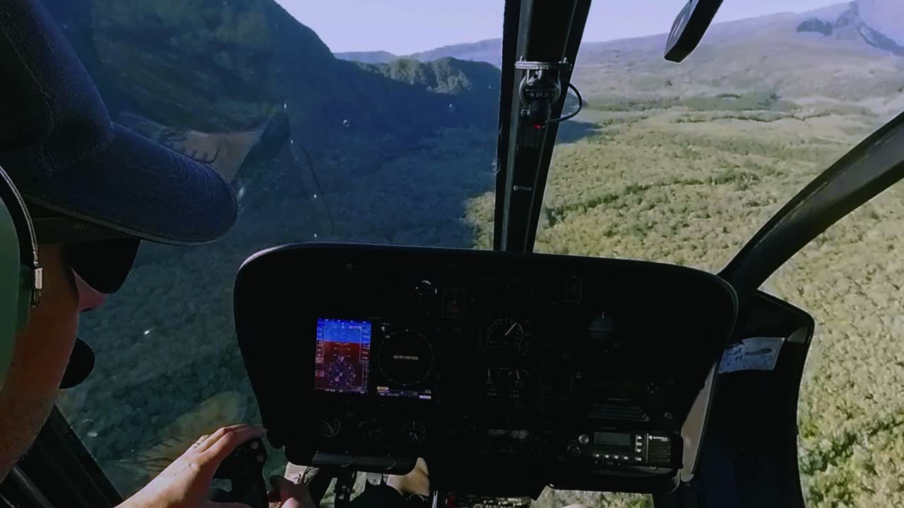 A stunning panoramic view from inside a helicopter flying over the breathtaking landscapes and volcanic terrains of Reunion Island.