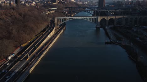 aerial flight up the Harlem River of NYC with views of the Three Bridges including the Highbridge former aqueduct