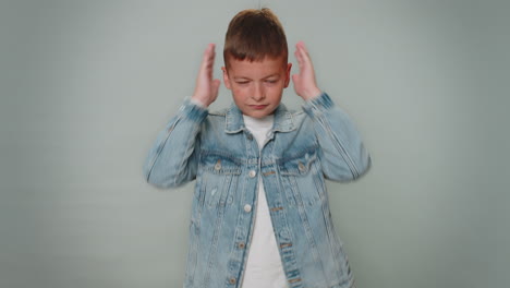 frustrated annoyed irritated toddler boy covering ears and gesturing no avoiding ignore hear advice