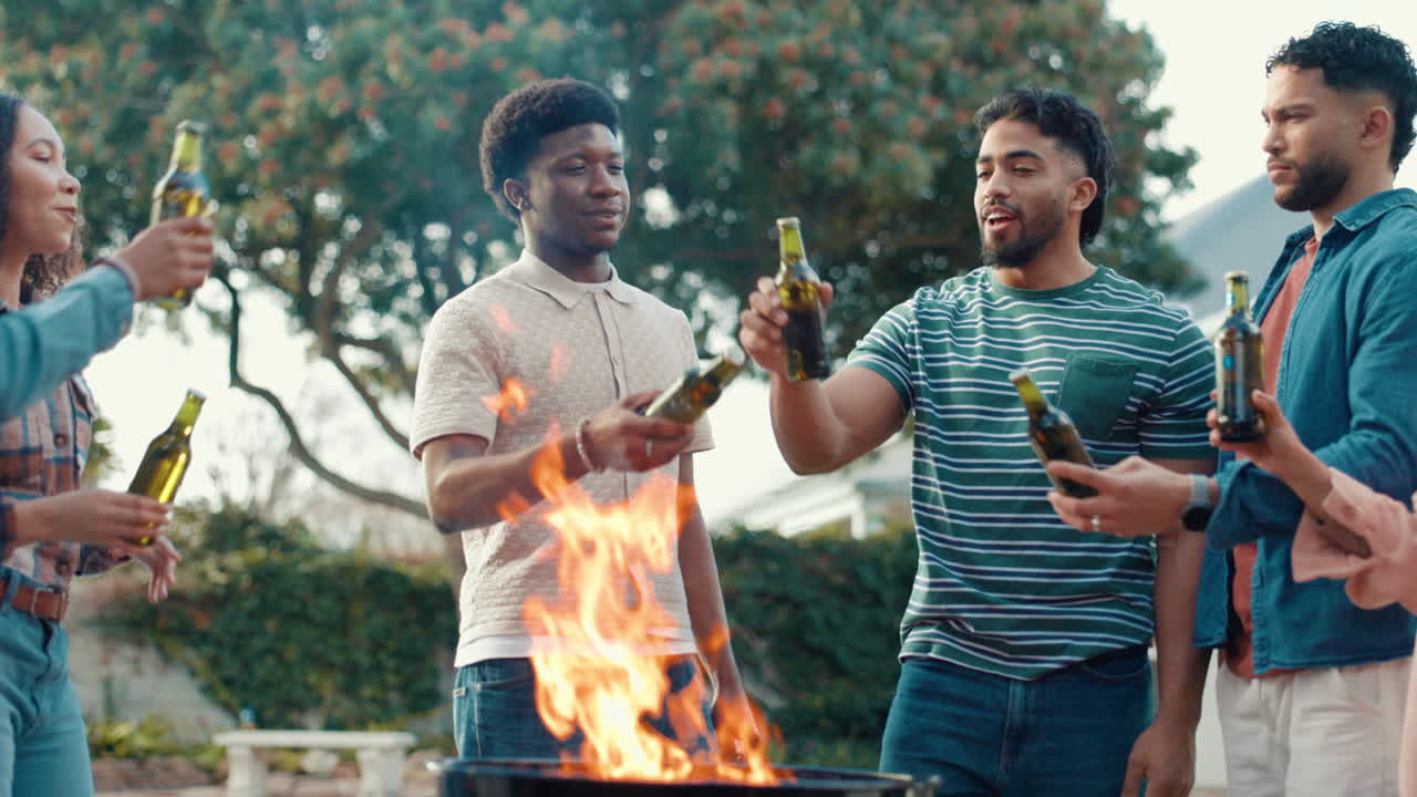 Group of friends celebrating with beers around a fire