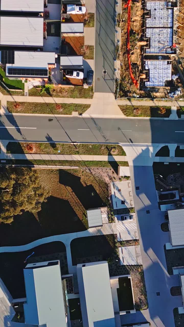 Vertical drone top down shot over newly built townhouses in Whitlam, Canberra. Modern housing development addressing Australia's housing crisis with high-density residential construction