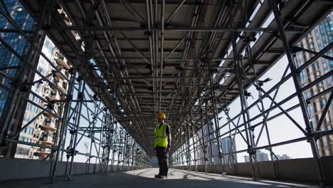 construction worker on scaffolding in urban setting