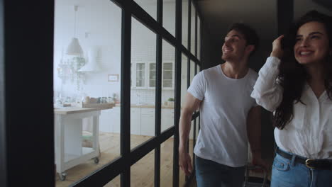 portrait of young couple entering home. happy family moving new house.
