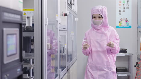scientist testers in protective uniform conducting research with tablet hud board inspection equipment in a high-tech laboratory during the day