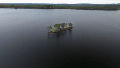 isolated island over tranquil lake during autumn season in sweden