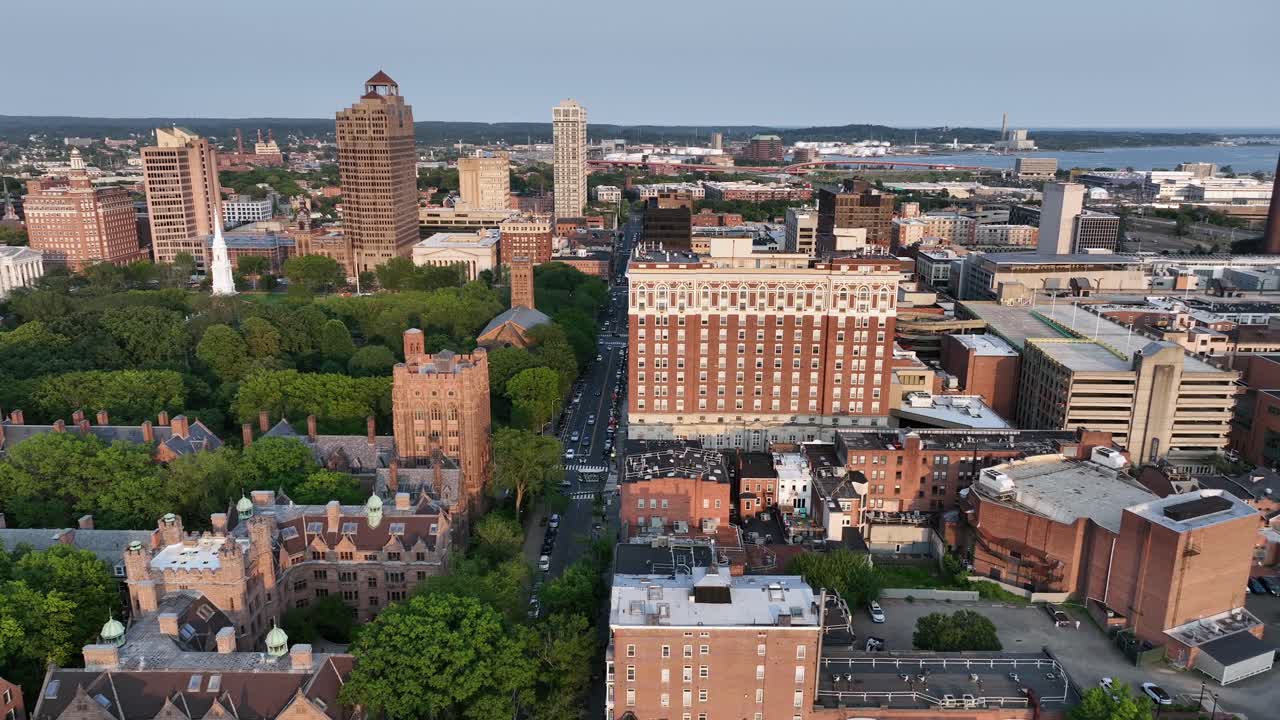 Aerial wide shot of Yale old campus university of New Haven. American City in Connecticut at sunset. Summer day with green trees. Connecticut Financial Center and Long Island Sound in downtown, USA