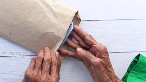 hands opening an envelope with money