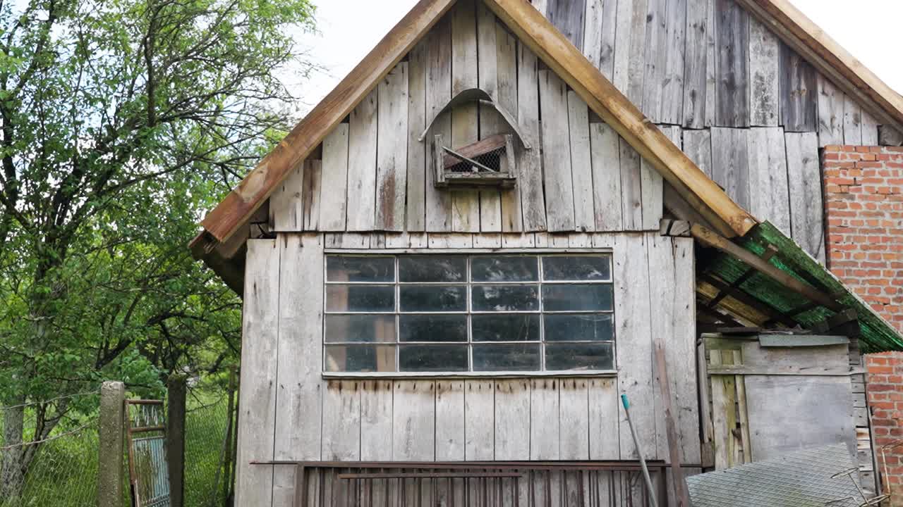 Rustic wooden house with glass windows and a small yard