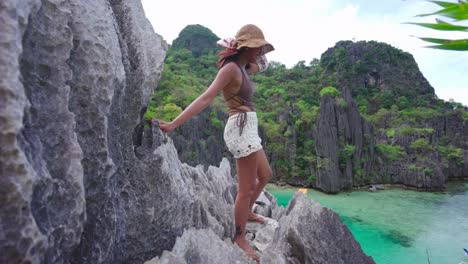 woman holding shawl in breeze on limestone rocks