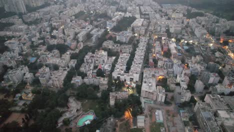 On-a-misty-evening-in-a-bustling-residential-area,-an-aerial-photograph-was-captured-of-Bengaluru,-Karnataka's-Electronic-City,-which-is-encircled-by-apartment-buildings