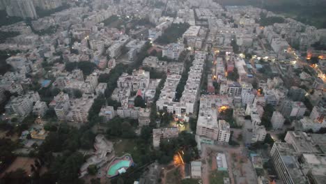 on a misty evening in a bustling residential area, an aerial photograph was captured of bengaluru, karnataka's electronic city, which is encircled by apartment buildings