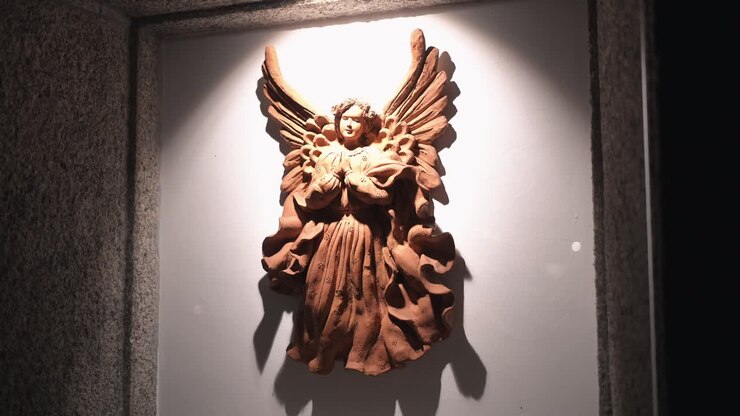 Terracotta Angel Sculpture in Artistic Lighting