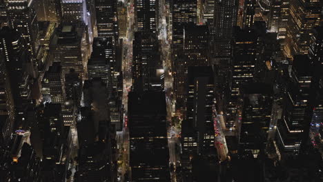 NYC-New-York-Aerial-v315-cinematic-birds-eye-view-drone-flyover-Midtown-Manhattan,-tilt-up-reveals-illuminated-downtown-skyscrapers-cityscape-at-night---Shot-with-Inspire-3-8k---September-2023