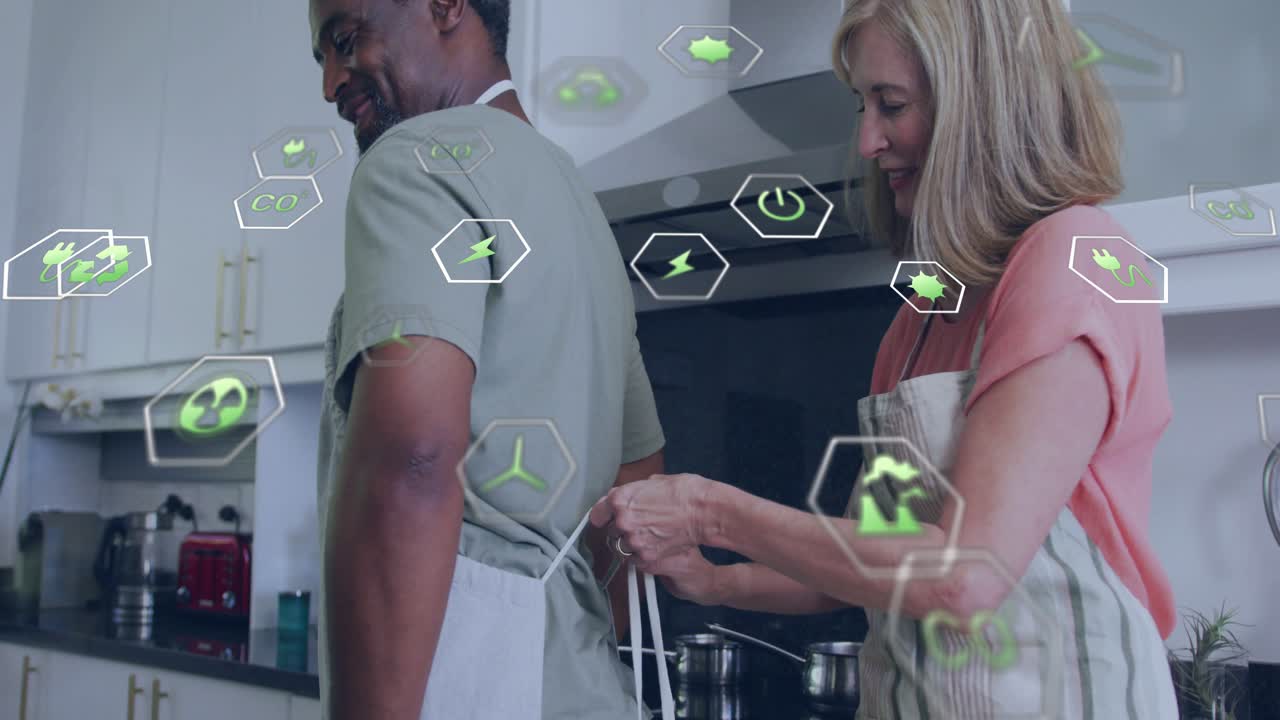 Woman tying man's apron after approaching, preparing meal, green hexagons floating around them