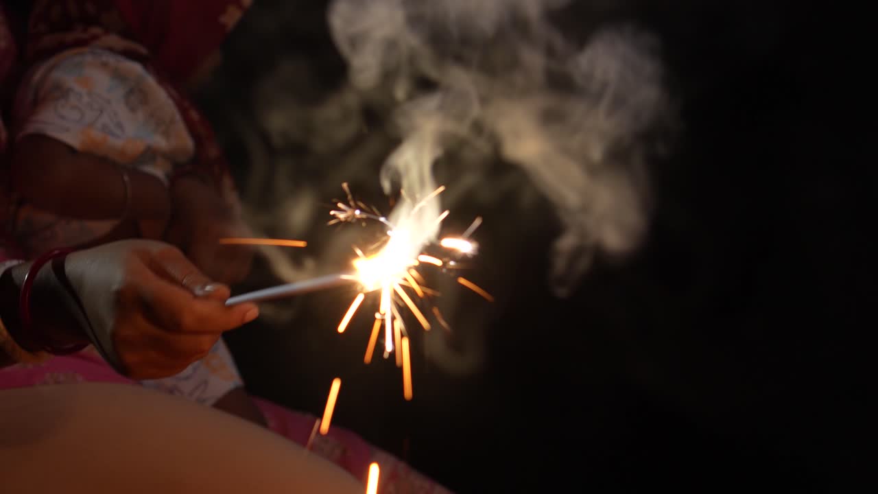 A mother and her child burning crackers on Diwali