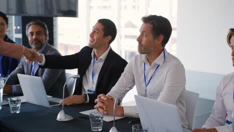 Business-delegates-shaking-hands-at-a-conference