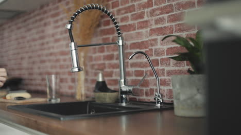 Filling-Glass-Of-Water-On-The-Kitchen-Faucet