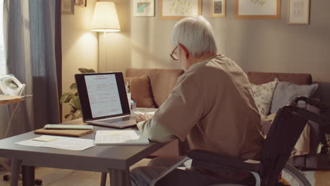 elderly man working remotely