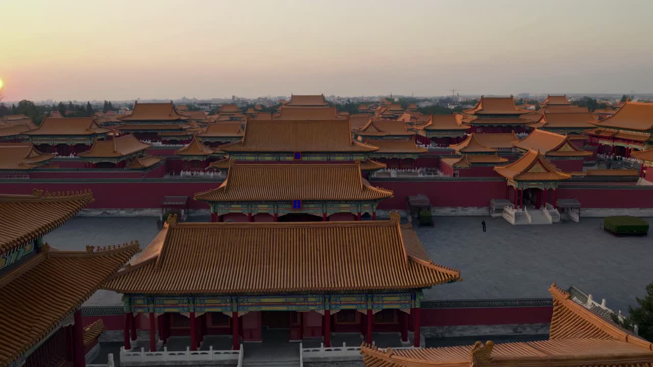Aerial video view of traditional Chinese architecture at sunset, showcasing intricate rooftops