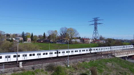 TTC-subway-passenger-rail-train-passing-by-urban-city-during-rush-hour-commute