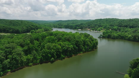 aerial view of tranquil river surrounded with lush vegetation in mousetail landing state park, linden, tennessee, usa - drone shot