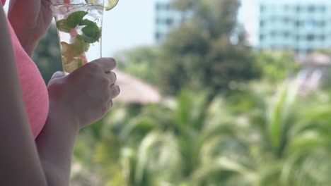 Frau-Steht-Auf-Balkon-Und-Rührt-Weichen-Mojito-Mit-Stroh