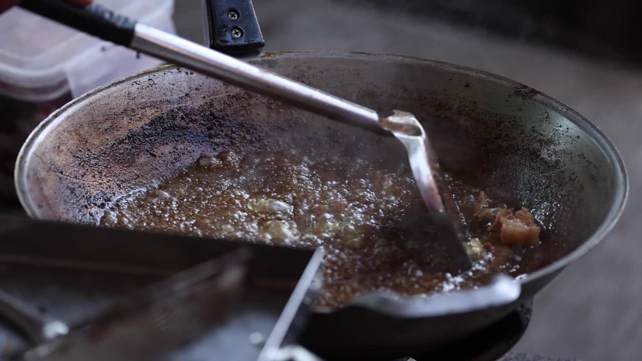 Cooking meat in a hot, sizzling frying pan
