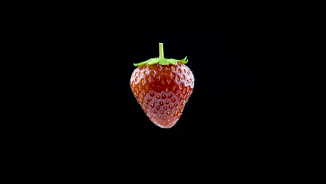 delicious strawberry rotates on a black background