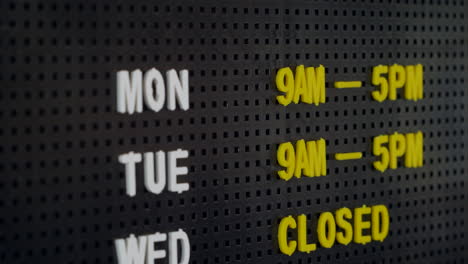 business opening hours on a retro pin board sign