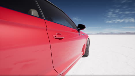 red car parked on white salt flats